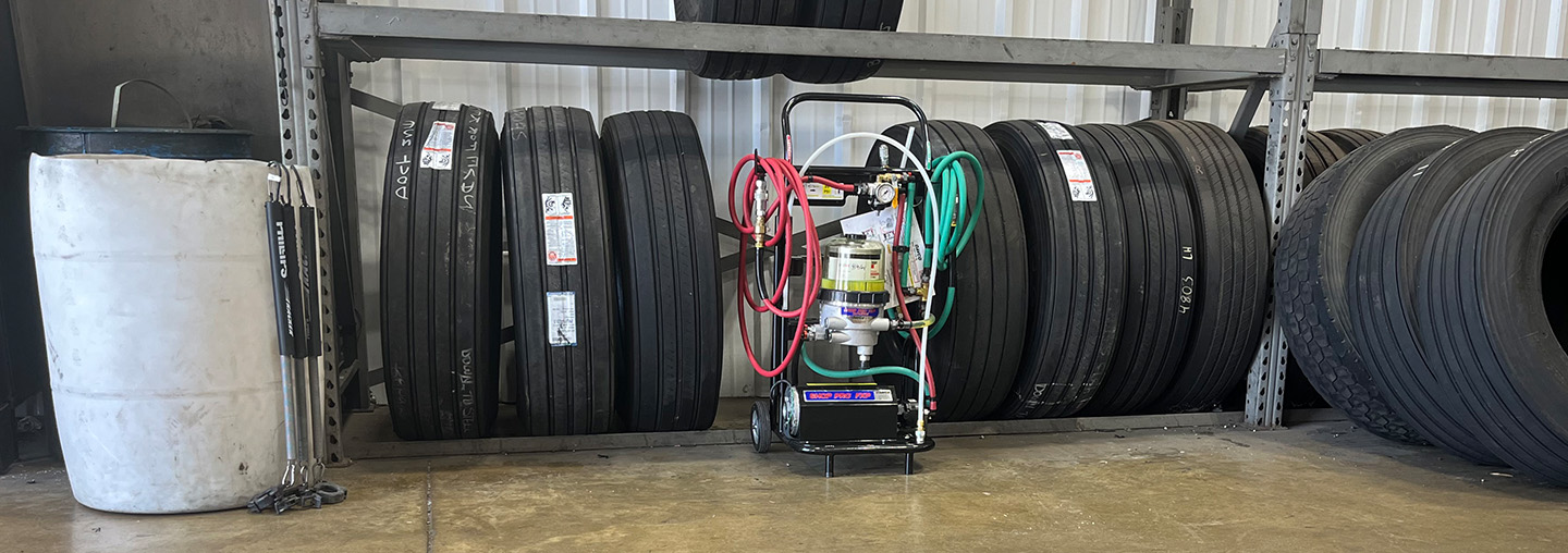 Shop pro fxp in warehouse next to a full tire rack